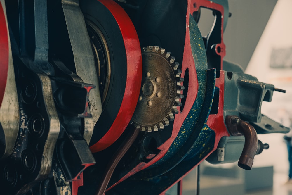 Close-up view of an engine cutaway showing gears and red-painted components